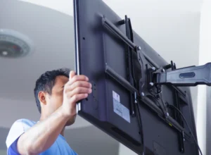 worker doing tv mounting